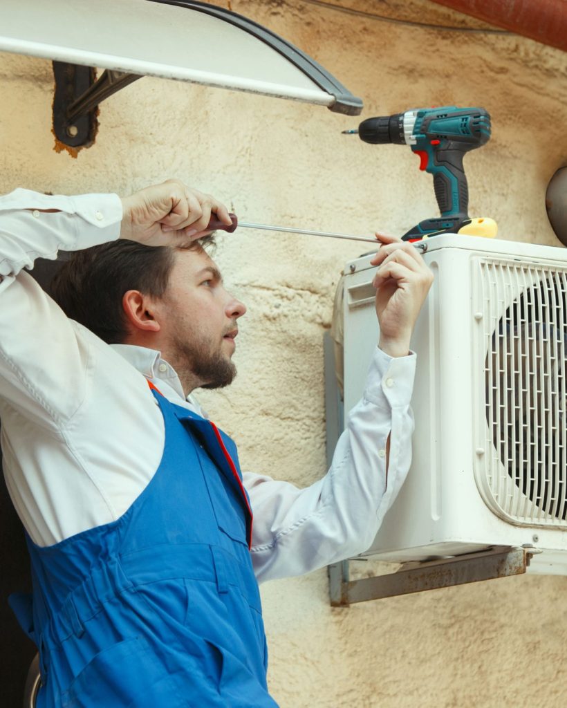 hvac-technician-working-capacitor-part-condensing-unit (1)